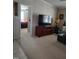 This living room features a large television, an entertainment center, and access to the main bedroom at 7027 Old 421 Rd, Liberty, NC 27298