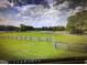 Large pasture with wood perimeter fencing, with grass extending to treeline under cloudy sky at 7027 Old 421 Rd, Liberty, NC 27298
