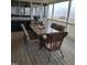 Covered patio features an outdoor dining area, a ceiling fan, and plenty of space for entertaining at 7027 Old 421 Rd, Liberty, NC 27298