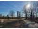 Picturesque property entrance with a gated driveway, water tower, and open fields under a clear blue sky at 7027 Old 421 Rd, Liberty, NC 27298