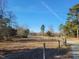 Scenic view of the home from the road, showing the expansive front yard and mature trees at 7027 Old 421 Rd, Liberty, NC 27298