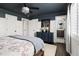 Bright and airy bedroom featuring hardwood floors, a dark blue accent wall, and natural light at 705 Greencove Ct, Raleigh, NC 27609