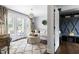 Bright living room with french doors leading to outdoor seating area and a large patterned rug at 705 Greencove Ct, Raleigh, NC 27609