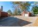 A detached brick garage features two doors and a side entry along a concrete driveway at 708 S Layton Ave, Dunn, NC 28334