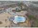 Aerial view of community pool and clubhouse in residential neighborhood at 724 Ancient Oaks Dr, Holly Springs, NC 27540