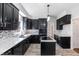 Spacious kitchen features a central island, dark cabinetry, and stainless steel appliances at 74 Wildcat Ln, Cameron, NC 28326