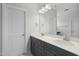 Bathroom featuring double sinks, gray cabinets, and a large mirror at 749 Aristocrat Ln, Knightdale, NC 27545