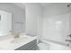 Bright bathroom featuring a quartz countertop vanity, modern fixtures, and a tub with shower at 749 Aristocrat Ln, Knightdale, NC 27545