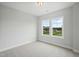 Bedroom with two windows, carpet, and neutral paint at 749 Aristocrat Ln, Knightdale, NC 27545