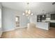 Dining room with chandelier provides open access to the bright, modern kitchen at 749 Aristocrat Ln, Knightdale, NC 27545