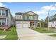 Beautiful two-story home featuring a two-car garage, covered porch, and manicured lawn at 749 Aristocrat Ln, Knightdale, NC 27545