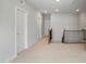 Upstairs hallway with doors, carpet, and decorative railing at 749 Aristocrat Ln, Knightdale, NC 27545