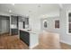 The kitchen has grey cabinets, stainless appliances, subway tile, and a center island with pendant lighting at 749 Aristocrat Ln, Knightdale, NC 27545