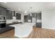 Modern kitchen featuring grey cabinetry, stainless appliances, a white subway tile backsplash, and a center island at 749 Aristocrat Ln, Knightdale, NC 27545
