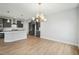 Bright kitchen featuring gray cabinetry, stainless appliances, a white subway tile backsplash, and pendant lights at 749 Aristocrat Ln, Knightdale, NC 27545