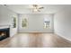 Spacious living room features a fireplace, ceiling fan, and natural light from large windows at 749 Aristocrat Ln, Knightdale, NC 27545