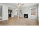 Open-concept living area featuring a fireplace, hardwood floors, and seamless flow to the kitchen at 749 Aristocrat Ln, Knightdale, NC 27545