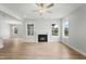 Bright living room with a fireplace, hardwood floors, and large windows offering natural light and views at 749 Aristocrat Ln, Knightdale, NC 27545