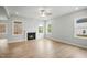 Spacious living room with a fireplace, hardwood floors, and ample natural light from multiple windows at 749 Aristocrat Ln, Knightdale, NC 27545