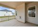 Covered porch features a wooden railing, a view of the neighborhood, and neutral-colored exterior at 749 Aristocrat Ln, Knightdale, NC 27545