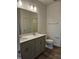 This bathroom has a double sink vanity, vinyl floors, and a view into the walk in closet at 813 Emmer St, Rolesville, NC 27571