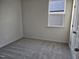 Empty bedroom with neutral carpet, base trim and one window for natural light at 813 Emmer St, Rolesville, NC 27571