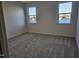This bedroom has neutral carpet and two windows that allow for natural light at 813 Emmer St, Rolesville, NC 27571