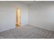 An empty bedroom with plush neutral carpet with an ensuite bathroom at 813 Emmer St, Rolesville, NC 27571