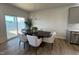 Bright dining area boasts modern chandelier, seating for six, and sliding glass doors to the backyard at 813 Emmer St, Rolesville, NC 27571