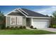 Charming single-story home featuring neutral siding, white trim, a two-car garage, and well-manicured landscaping at 813 Emmer St, Rolesville, NC 27571