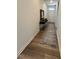 Welcoming entry hall with console table, modern lamp, neutral rug, and wood flooring at 813 Emmer St, Rolesville, NC 27571