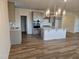 Modern kitchen with gray cabinets, stainless appliances, and a stylish island with an overhang at 813 Emmer St, Rolesville, NC 27571