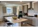 Bright eat-in kitchen with large island, modern appliances, light gray cabinets, and view of the window at 813 Emmer St, Rolesville, NC 27571