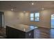 Open-concept living room with wood floors, recessed lighting, and sliding glass door to the balcony at 813 Emmer St, Rolesville, NC 27571