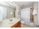 Bathroom with shower-tub combo and a wooden sink vanity at 8717 Carradale Ct, Wake Forest, NC 27587