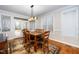 Cozy dining area with hardwood floors, a modern light fixture, and access to the outdoor patio at 8717 Carradale Ct, Wake Forest, NC 27587