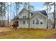 Back exterior featuring light green siding and mature trees at 8717 Carradale Ct, Wake Forest, NC 27587