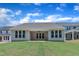 Exterior of a single-story home showing the covered patio and sodded backyard with blue skies at 9169 Dupree Meadow Dr # 26, Angier, NC 27501
