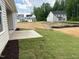 New home construction featuring a lawn being installed and mulched landscaping next to a concrete patio at 9169 Dupree Meadow Dr # 26, Angier, NC 27501