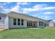 Exterior of a single-story home showcasing the covered patio and freshly sodded backyard at 9169 Dupree Meadow Dr # 26, Angier, NC 27501
