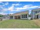 Exterior of a single-story home with a covered patio and freshly sodded backyard with lush green grass at 9169 Dupree Meadow Dr # 26, Angier, NC 27501