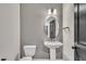 Half bathroom with a pedestal sink, round mirror and modern lighting fixtures at 9169 Dupree Meadow Dr # 26, Angier, NC 27501