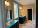 Elegant bathroom featuring double vanities, mirrors, and a window offering natural light at 9169 Dupree Meadow Dr # 26, Angier, NC 27501