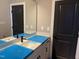 Bathroom with a sleek black faucet, quartz countertop, and stylish black door at 9169 Dupree Meadow Dr # 26, Angier, NC 27501