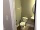 Small, bright half-bathroom featuring a white toilet and sink, with modern fixtures at 9169 Dupree Meadow Dr # 26, Angier, NC 27501