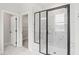 Modern bathroom featuring marble-look tile and a glass enclosed shower with black trim at 9169 Dupree Meadow Dr # 26, Angier, NC 27501