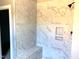 Modern shower featuring marble-look tile, a built in bench and wall niche at 9169 Dupree Meadow Dr # 26, Angier, NC 27501