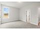 Cozy bedroom with plush carpet, bright window, and a doorway leading to another room at 9169 Dupree Meadow Dr # 26, Angier, NC 27501
