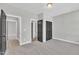 Spacious bedroom featuring neutral carpeting, paint, closet, and doorways to en suite bathroom at 9169 Dupree Meadow Dr # 26, Angier, NC 27501