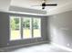Bright bedroom with a ceiling fan and large windows offering views of the outdoors, creating a peaceful retreat at 9169 Dupree Meadow Dr # 26, Angier, NC 27501